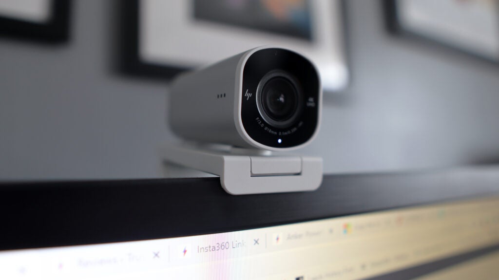 The HP 960 4K Streaming Webcam ontop of a monitor