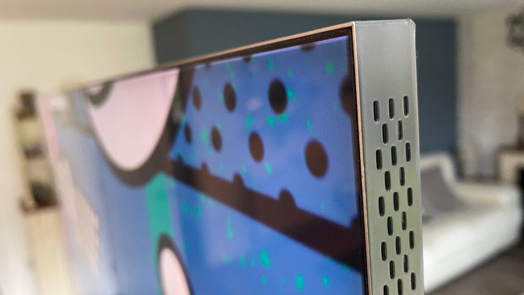 Corner detail of the Samsung QN900C, showing the perforated edges that let the sound emerge from the Object Tracking Sound speaker system.