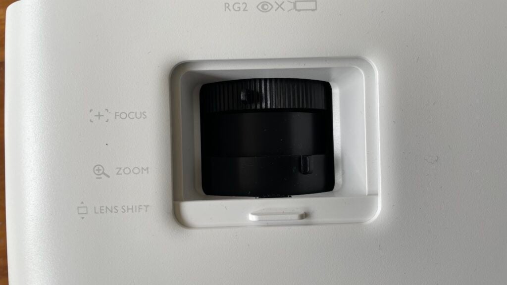 A window on the W2710i's top edge provides access to zoom, focus and vertical lens shift adjustments. 