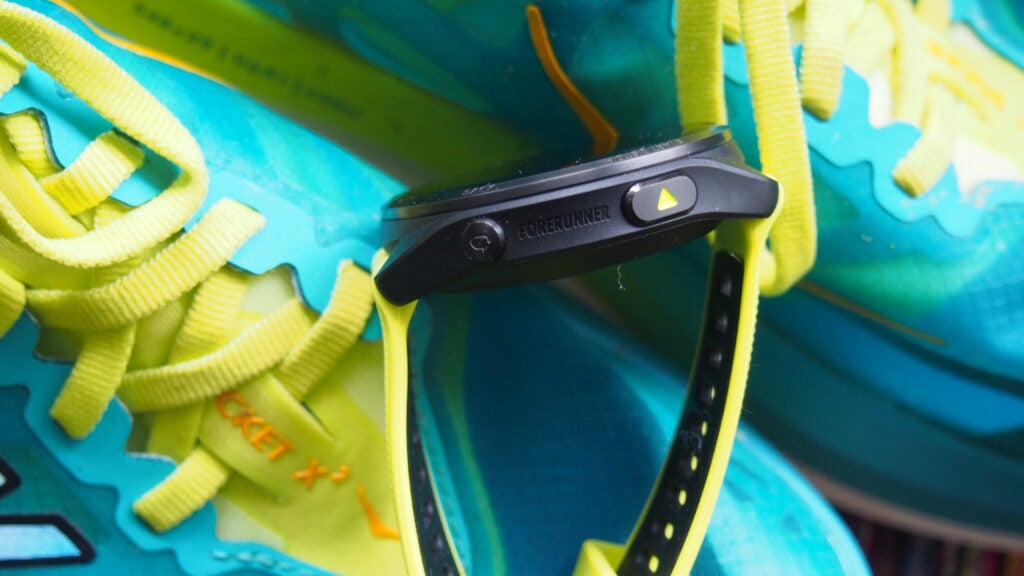 The side of the Garmin Forerunner 965 with its accented buttons