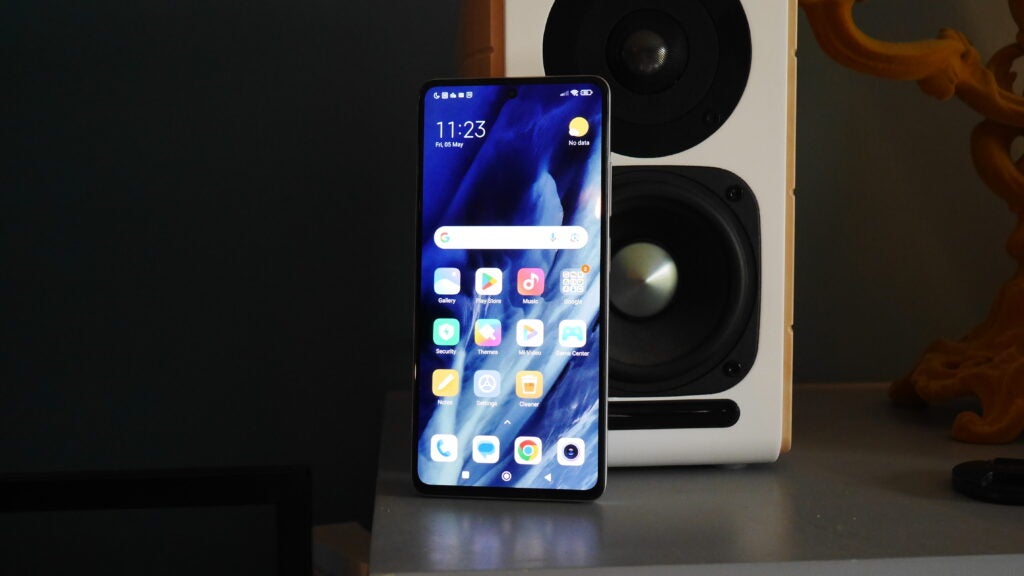 Xiaomi Redmi Note 12 Pro Plus leaning against a speaker