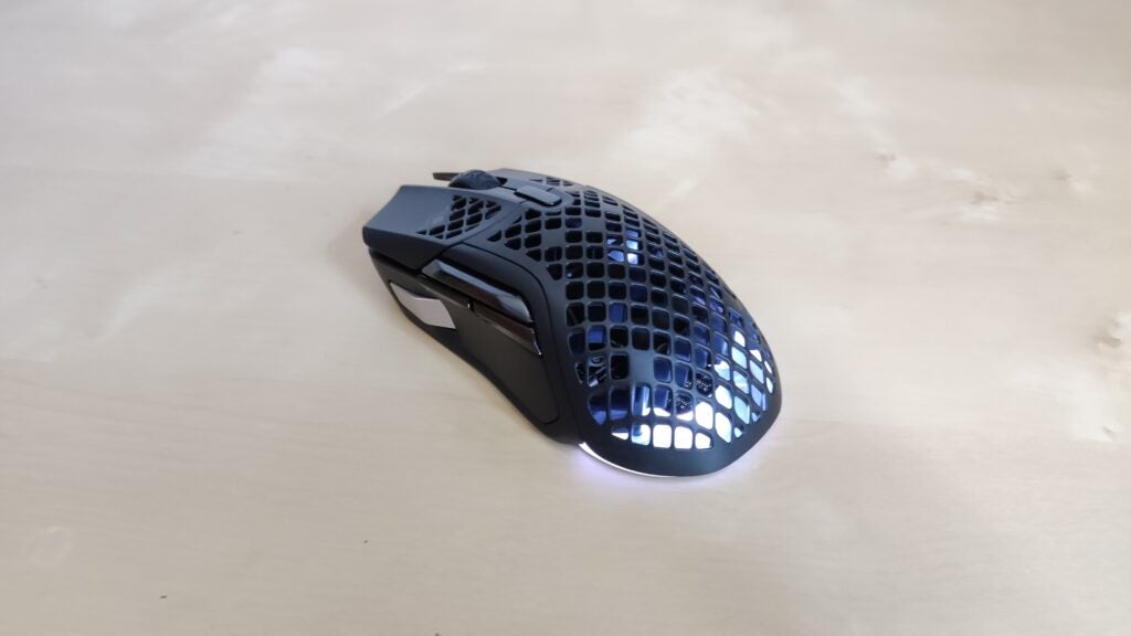 The SteelSeries Aerox 5 Wireless with lights shining through its back