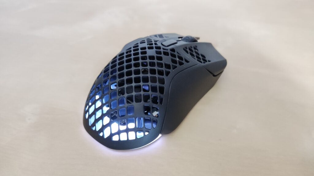 A side shot of the SteelSeries Aerox 5 Wireless with its lights showing