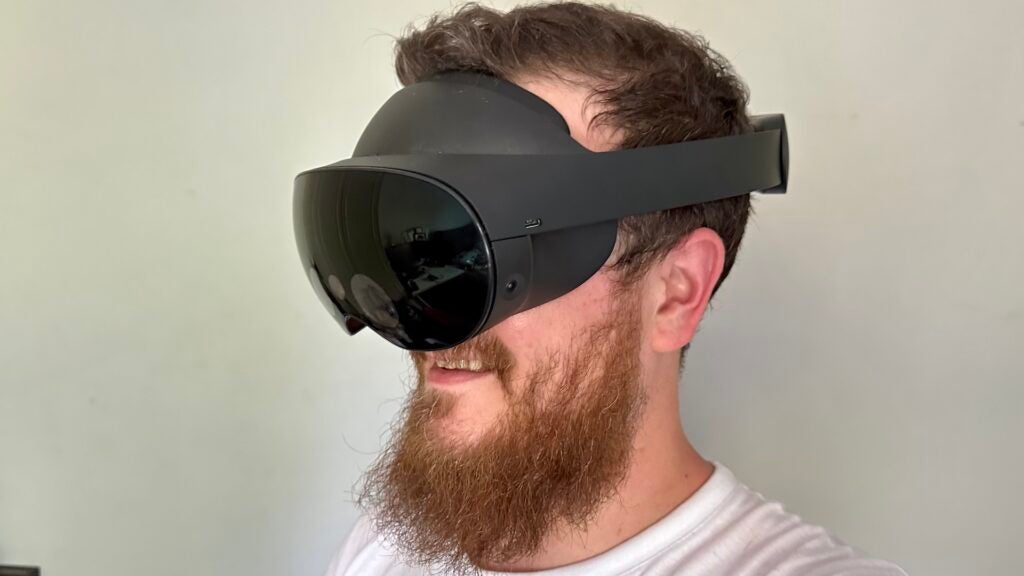 Man wearing Meta Quest Pro VR headset.