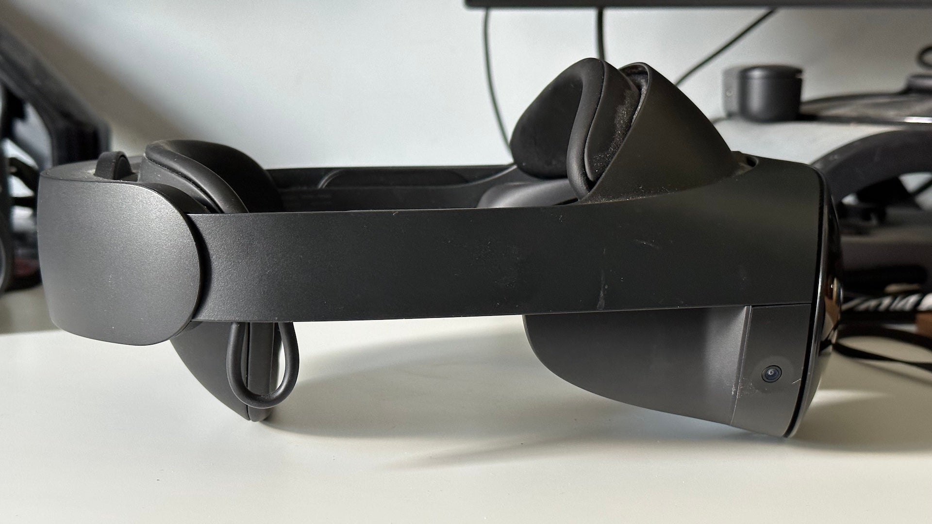 Left ImageMeta Quest Pro VR headset on a white desk.Meta Quest Pro virtual reality headset on a desk.