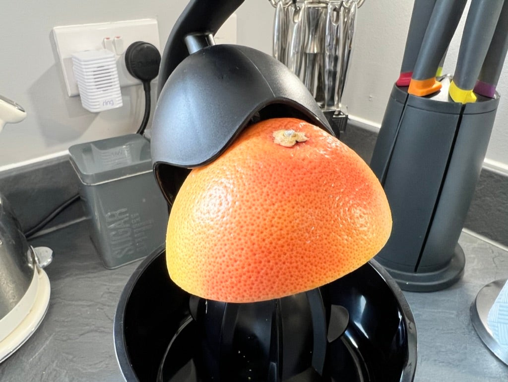 Salter Deluxe Citrus Juicer with a grapefruit.