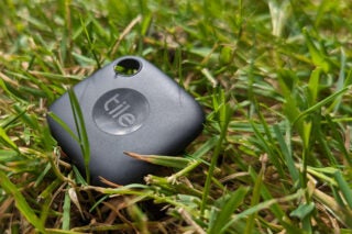 Tile Mate tracker on grass showing logo and design.