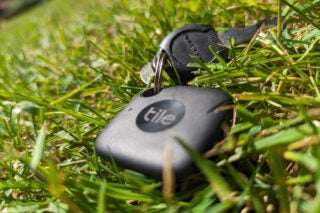 Tile Mate tracker attached to keys in grass.