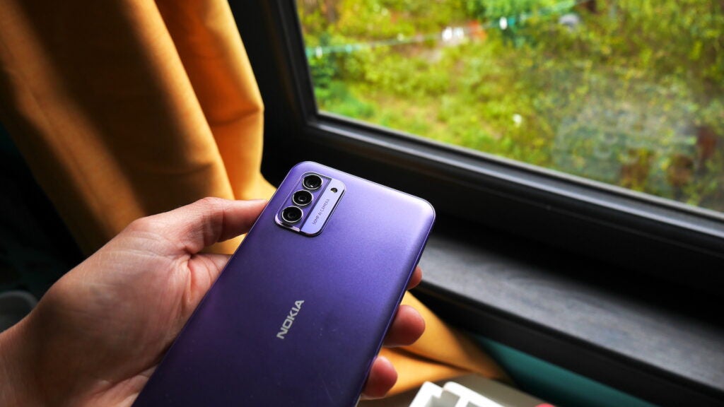 Nokia G42 5G in hand, showing off the purple finish