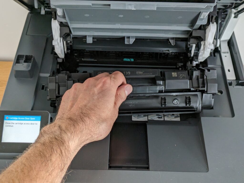 Photo of the toner cartridge being reinserted