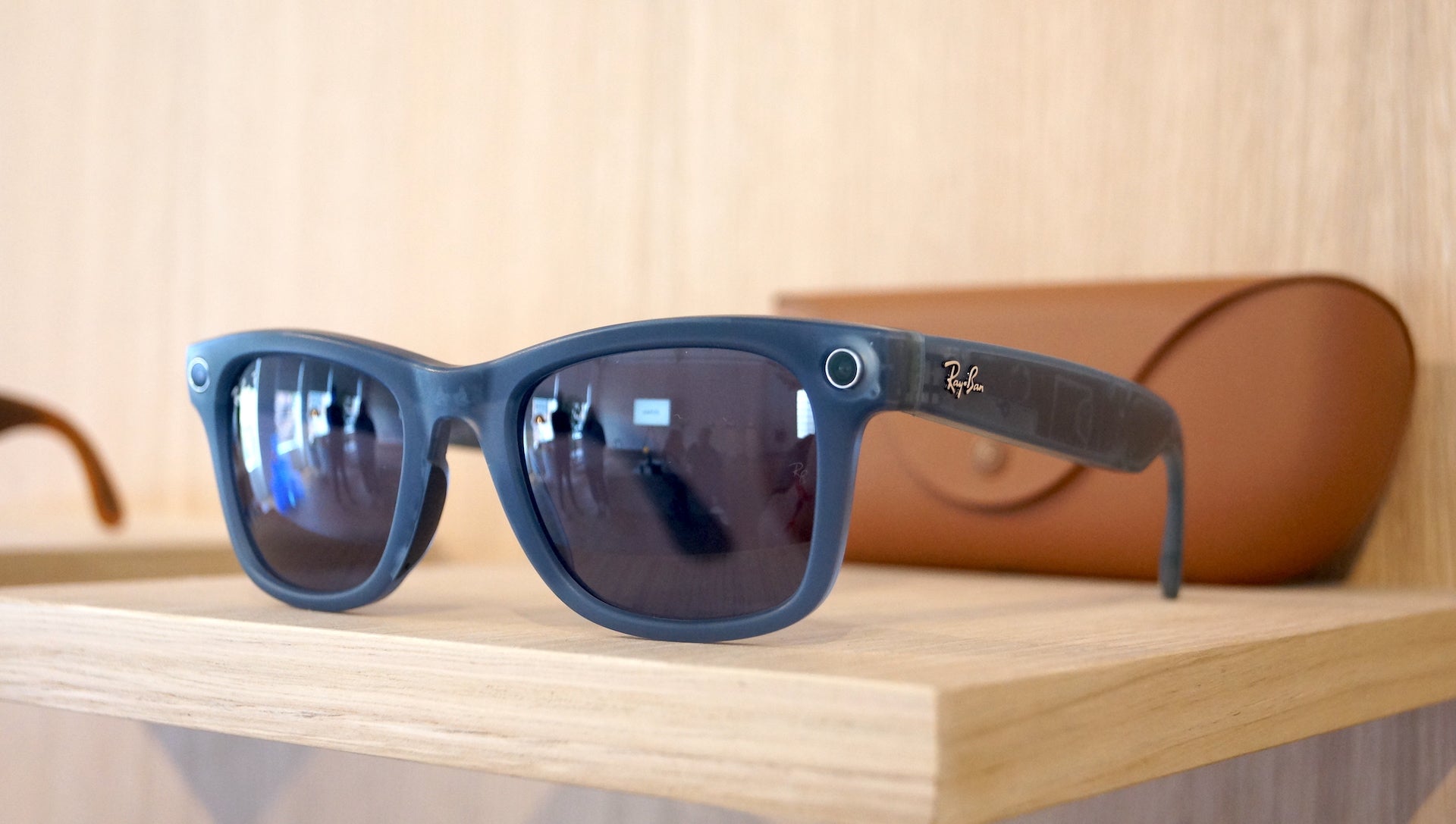 Left ImageRay-Ban sunglasses on wooden shelf with case in background