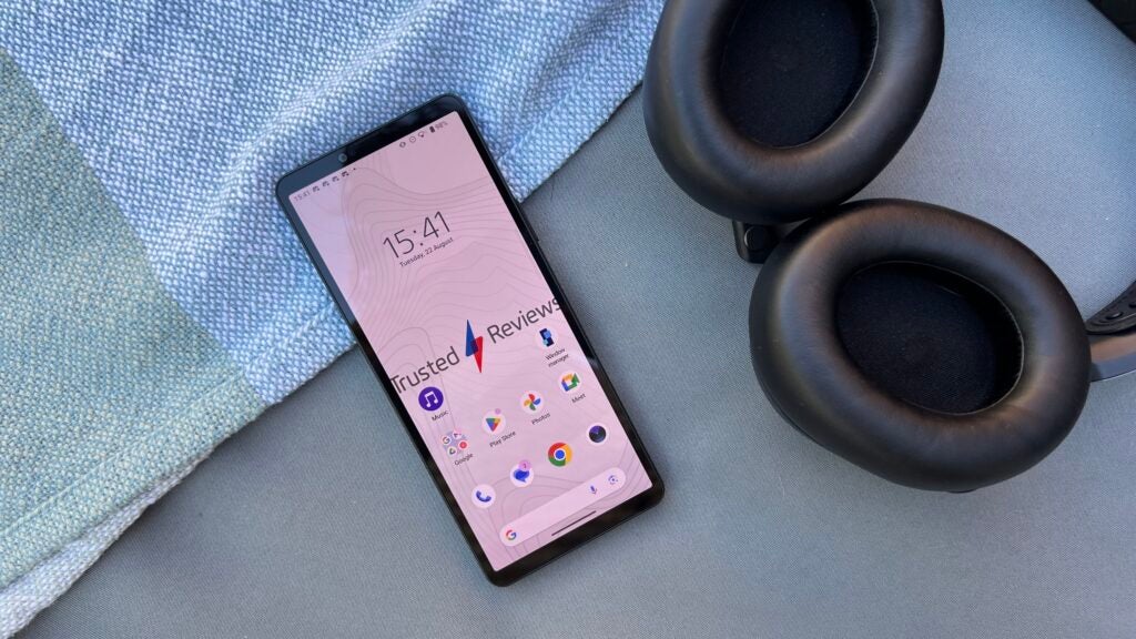Sony Xperia 10 V next to a pair of headphones
