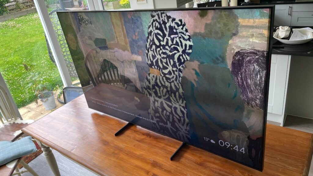 The Sony 65X95L from a high angle to the right.Sony 65-inch TV displaying artwork on screen in living room.
