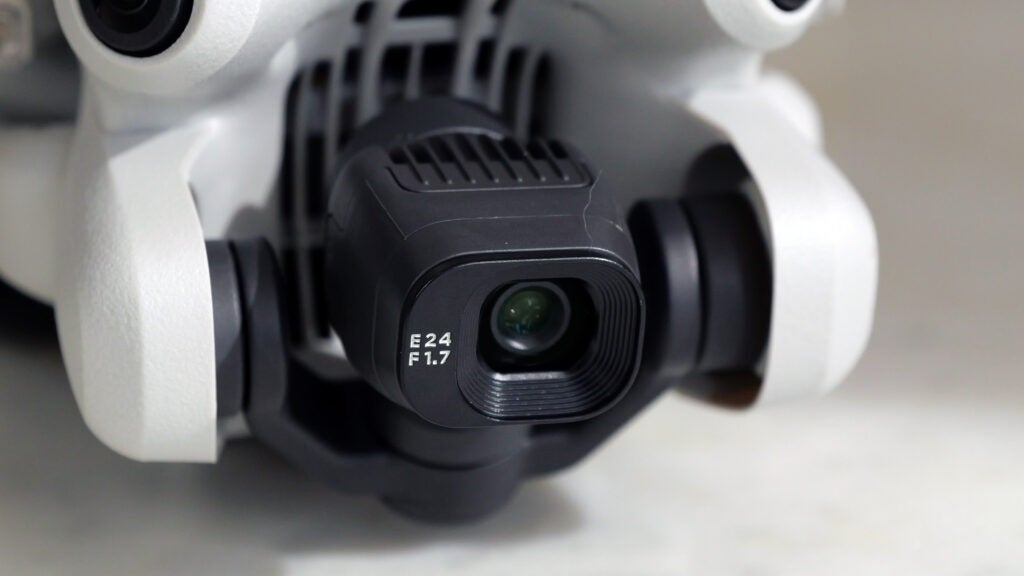 Front camera on the DJI Mini 4 ProClose-up of DJI Mini 4 Pro drone's camera lens with specs.