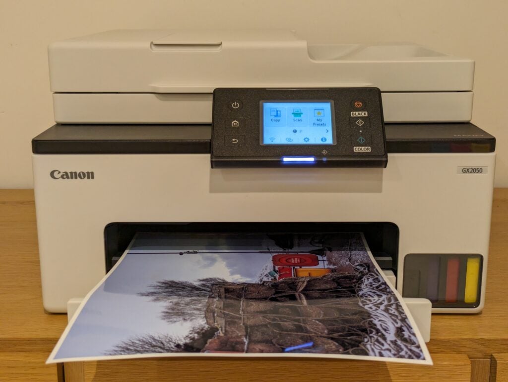 Front view of the printer with photo in paper output