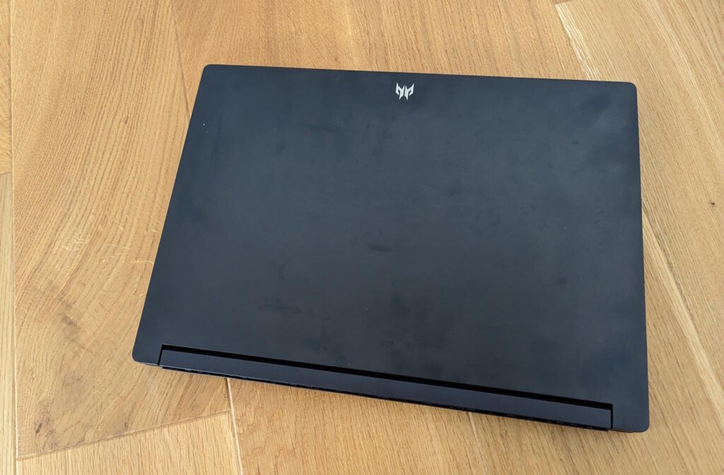 Acer Predator Triton 17 X gaming laptop closed on wooden floor.