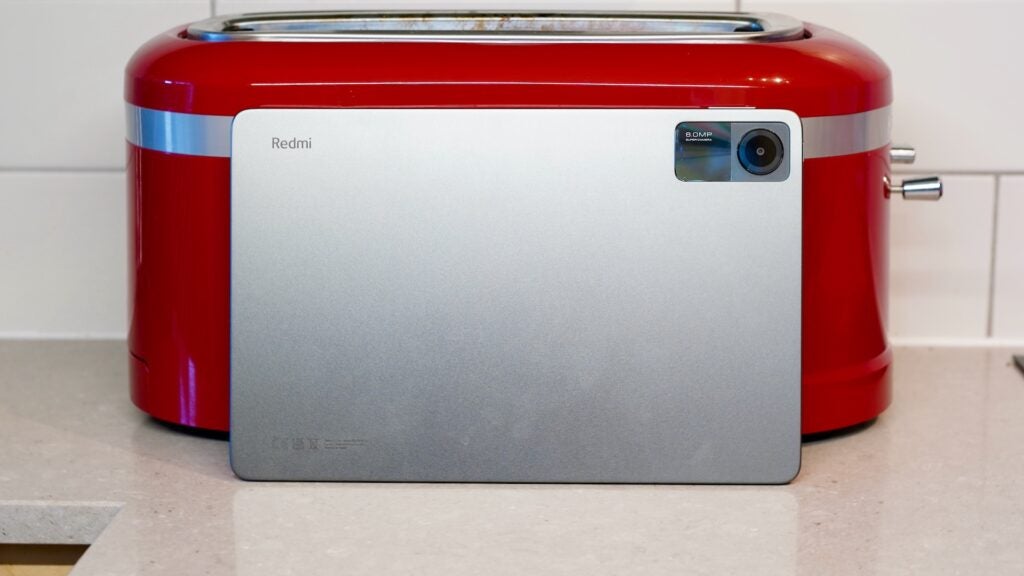 Redmi Pad SE leaning against toaster