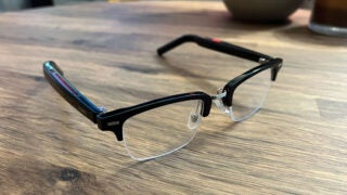 The Huawei Eyewear 2 smart glasses sitting on a table.