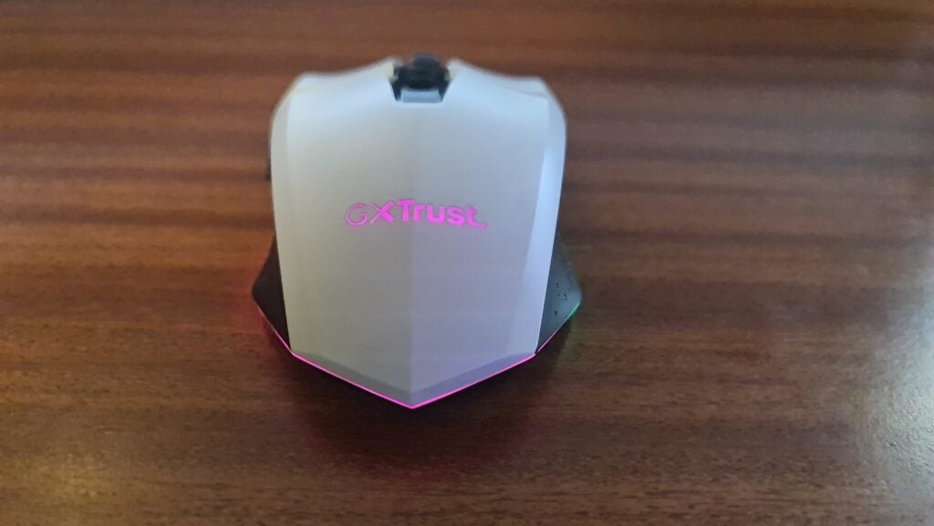 Back of the Trust GXT 110 Felox with trust logo and skirting lit up in Fuschia.