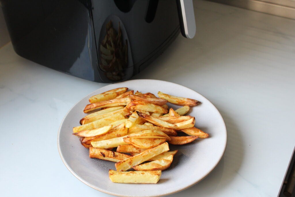 Salter XL Digital Steam Air Fryer chipsGolden french fries on plate with air fryer in background