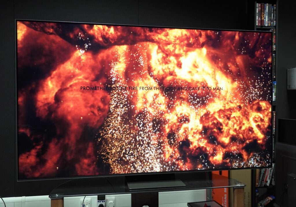 Samsung QE75QN800C TV displaying vibrant fire imagery.