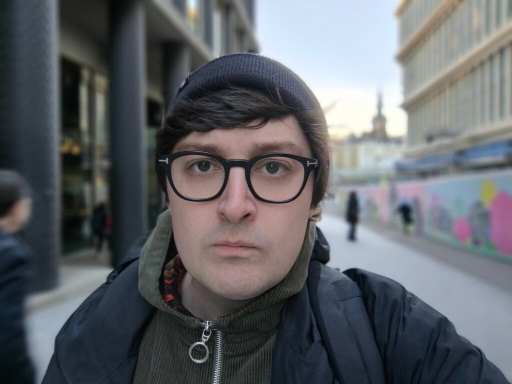 Poco X6 Pro selfie cameraMan with glasses in focus with blurred background.