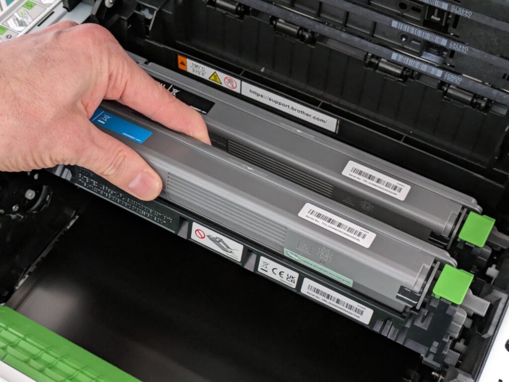 Inserting the Cyan toner in front of the black. The yellow and magenta cartridges are removed.