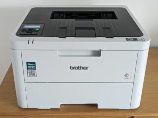 Front shot of laser printer, showing white plastics with black top panel