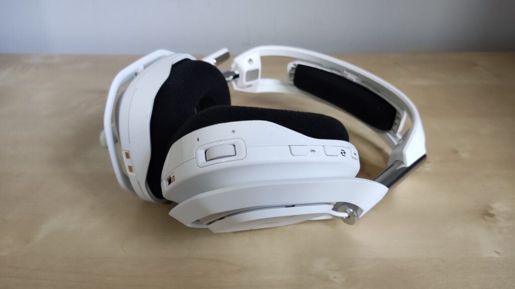 The Astro A50 X lying on its side with one ear cup bend over