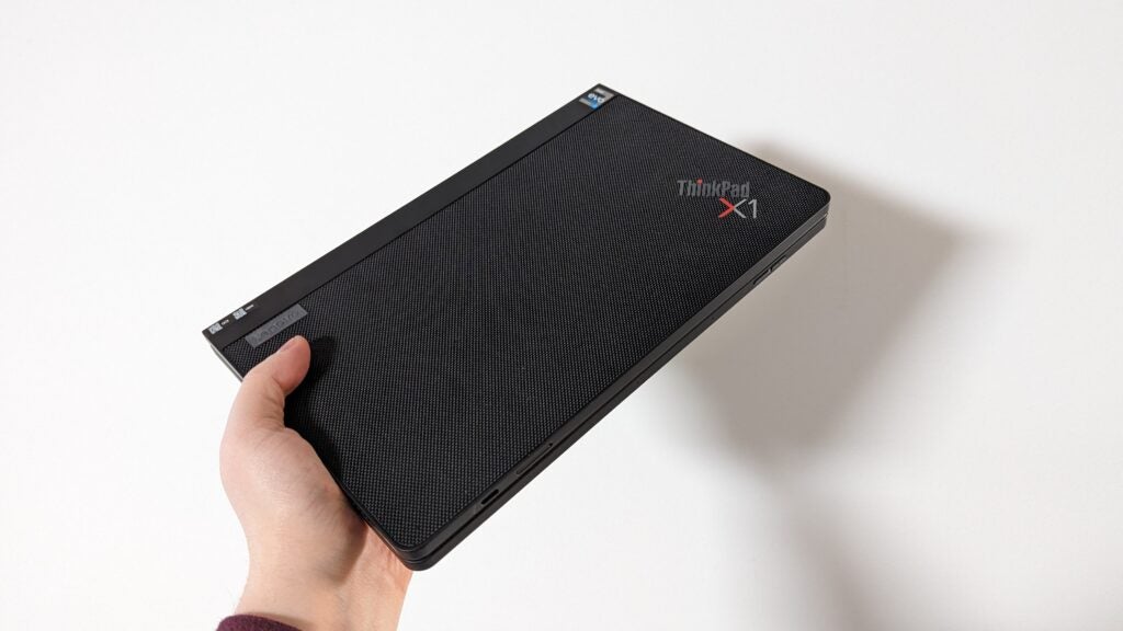 Lenovo ThinkPad X1 Fold fold in handHand holding Lenovo ThinkPad X1 Fold closed.