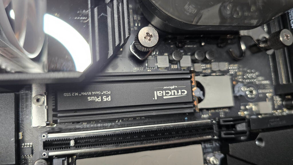 Crucial's P5 Plus M.2 PCIe 4.0 SSD being tested in a PCCrucial P5 Plus SSD installed on a computer motherboard.