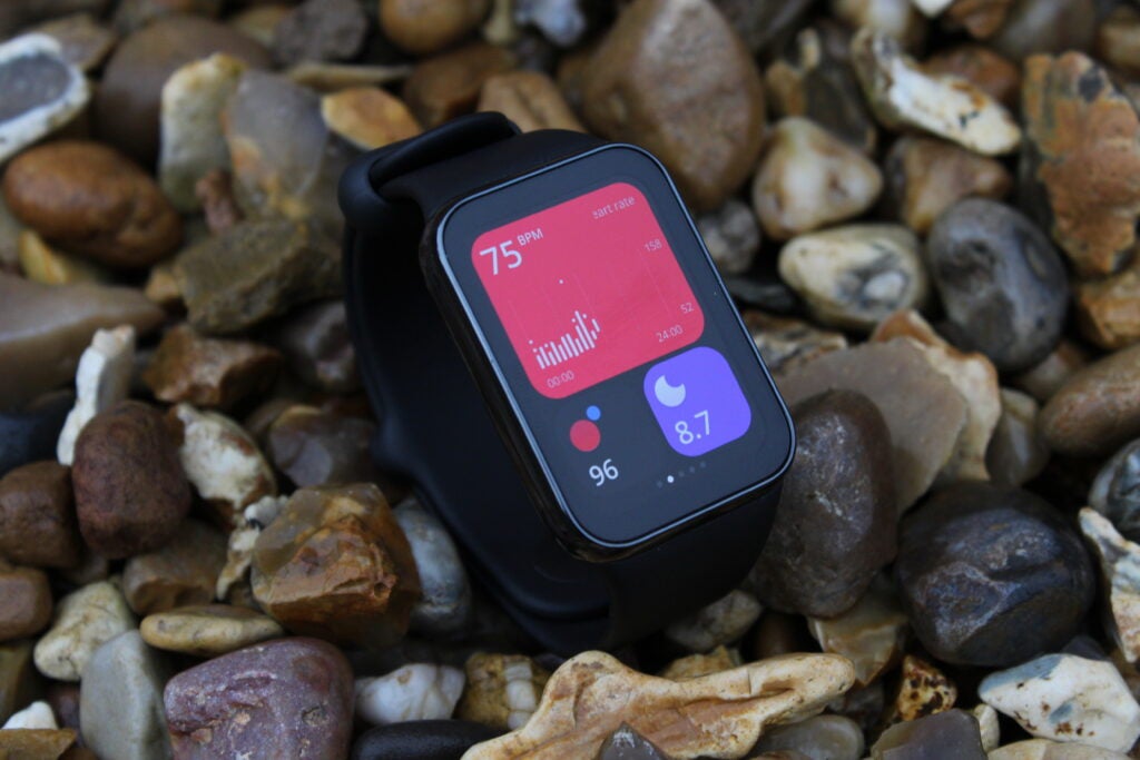 Xiaomi Smart Band 8 Pro on rocks face up showing data