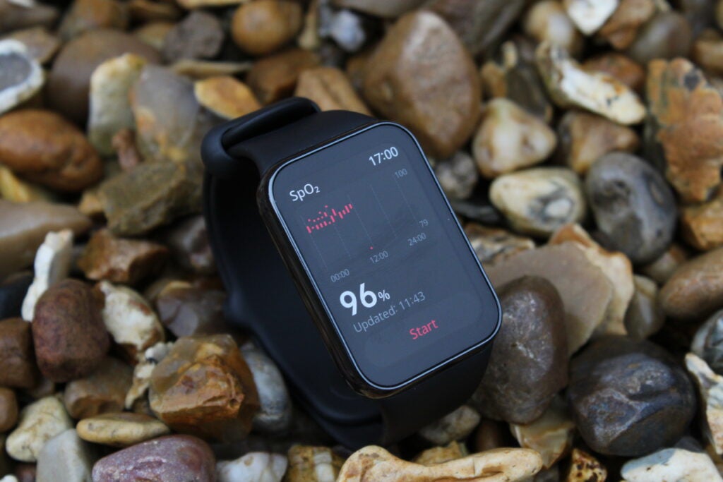Xiaomi Smart Band 8 Pro on rocks face up showing data sp02